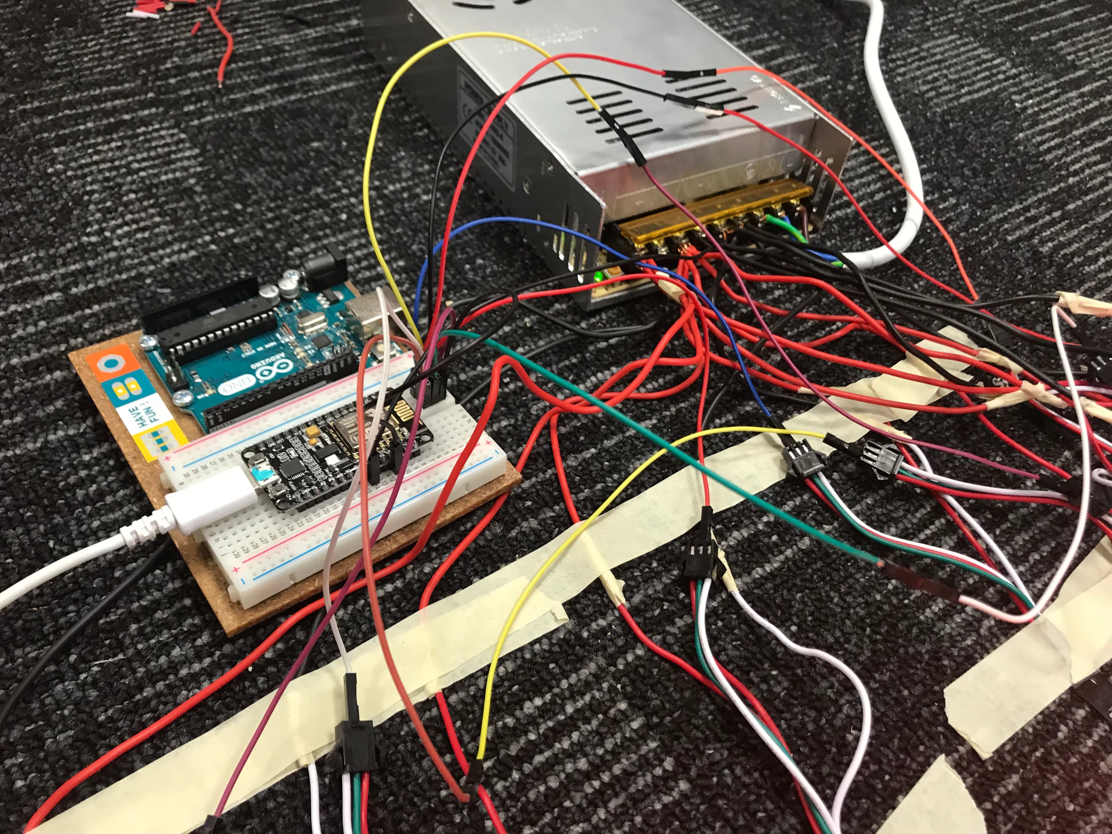 NodeMCU microcontroller alongside an Arduino board and cables galore